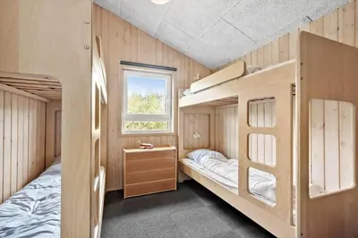 a bedroom with two bunk beds and a window at LK350-Lokken-Piasvej-11 in Løkken