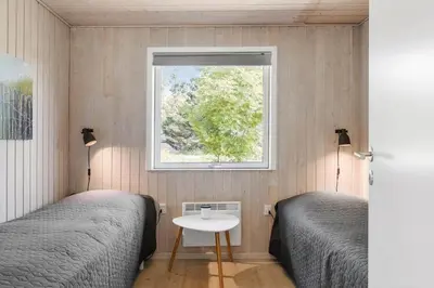 a bedroom with two beds and a window at LK1394-Lokken-Lisevej-5 in Løkken