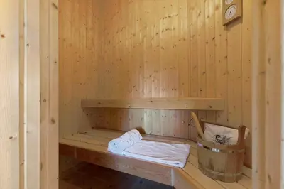 a sauna with a bench and a bucket in it at LK1804-Lokken-Kristavej-43 in Løkken
