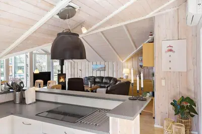a room with a kitchen and a living room with a table at LK1804-Lokken-Kristavej-43 in Løkken