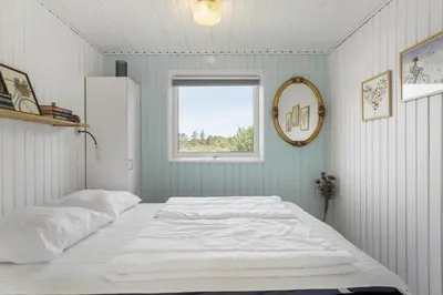 a bedroom with two beds and a window at LK1935-Lokken-Pernillevej-17 in Løkken