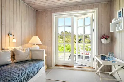 a bedroom with a bed and a window and a desk at LK344-Lokken-Ragnhildsvej-3 in Løkken