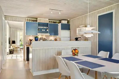 a kitchen and dining room with a table and chairs at LK344-Lokken-Ragnhildsvej-3 in Løkken