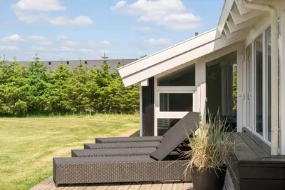 a porch of a house with a bench on it at LK780-Lokken-Margrethevej-4 in Løkken