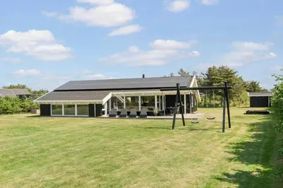 a house with a large yard with a swing at LK780-Lokken-Margrethevej-4 in Løkken