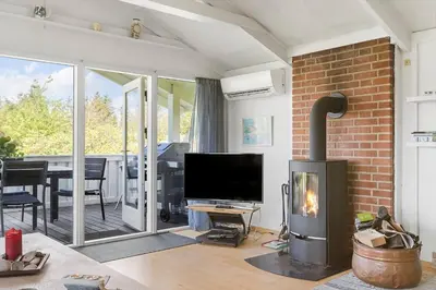 a living room with a fireplace and a television at LK2046-Lokken-Kristavej-25 in Løkken