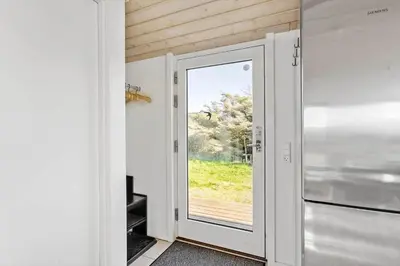 a door leading to a kitchen with a view of a yard at LK281-Lokken-Lonesvej-5 in Løkken