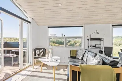 a living room with a couch and a table at LK281-Lokken-Lonesvej-5 in Løkken