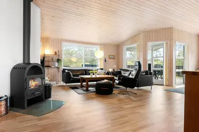 a living room with a wood burning stove in it at LK1325-Lokken-Karinavej-59 in Løkken