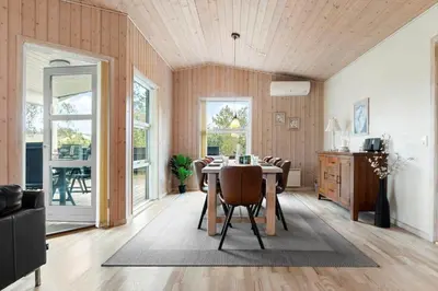 a dining room with a table and some chairs at LK1325-Lokken-Karinavej-59 in Løkken