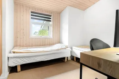 a room with two beds and a window at LK1325-Lokken-Karinavej-59 in Løkken