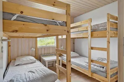 two bunk beds in a small room with a bed at LK1786-Lokken-Nannasvej-18 in Løkken