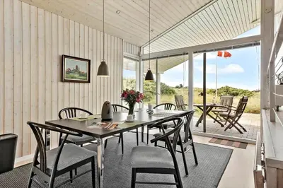 a dining room with a table and some chairs at LK1786-Lokken-Nannasvej-18 in Løkken