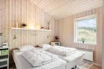 a bedroom with two beds and a window at LK1786-Lokken-Nannasvej-18 in Løkken