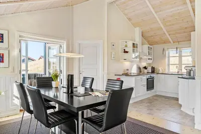 a kitchen with a black table and black chairs at LK322-Lokken-Ornegaardsvej-27 in Løkken
