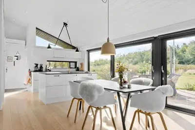 a kitchen and dining room with a table and chairs at LK1946-Lokken-Kringelbaekvej-5 in Løkken