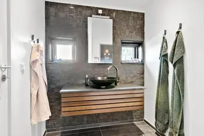 a bathroom with a sink and a mirror at LK1946-Lokken-Kringelbaekvej-5 in Løkken