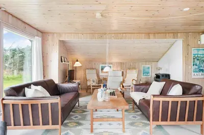a living room with leather couches and a table at LK2071-Lokken-Marensvej-3 in Løkken