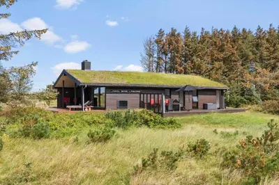 a house with a grass roof on top of a field at LK2007-Lokken-Stellavej-11 in Løkken