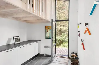 a kitchen with white cabinets and a staircase in a house at LK2007-Lokken-Stellavej-11 in Løkken