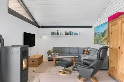 a living room with a couch and a fireplace at LK2007-Lokken-Stellavej-11 in Løkken