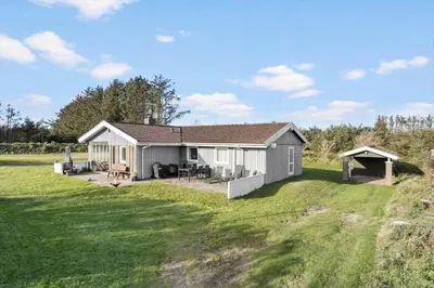 a small house in a field with a yard at LK561-Lokken-Lisbethsvej-1 in Løkken