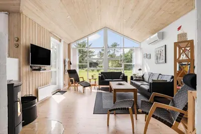 a living room with a couch and a table at LK310-Lokken-Magdalenevej-39 in Løkken