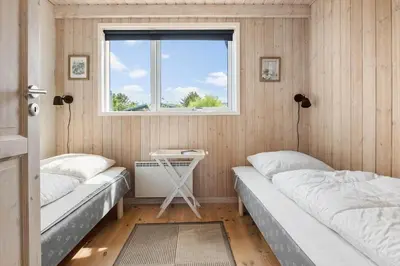 two beds in a small room with a window at LK310-Lokken-Magdalenevej-39 in Løkken