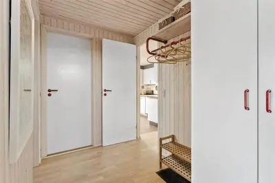 a hallway with white walls and a wooden ceiling at LK1793-Lokken-Jettesvej-3 in Løkken