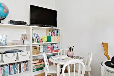 a room with a table and chairs and a tv at LK1790-Lokken-Gronhoj-Strandvej-174 in Løkken
