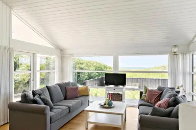 a living room with a couch and a tv at LK1790-Lokken-Gronhoj-Strandvej-174 in Løkken