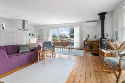 a living room with a purple couch and a table at LK2115-Lokken-Marthasvej-7 in Løkken