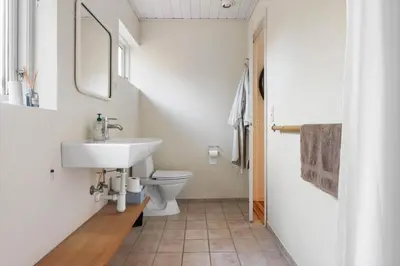 a bathroom with a sink and a toilet at LK2115-Lokken-Marthasvej-7 in Løkken