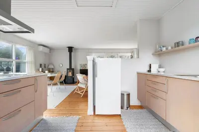 a kitchen with a refrigerator and a dining room at LK2115-Lokken-Marthasvej-7 in Løkken