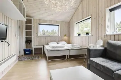 a living room with a bed and a couch at LK902-Lokken-Mievej-42 in Løkken