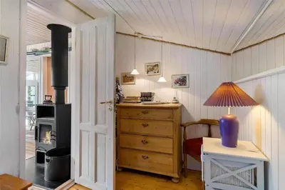 a room with a desk and a wood stove at LK564-Lokken-Piasvej-17 in Løkken