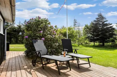 two chairs and a table on a patio at LK564-Lokken-Piasvej-17 in Løkken