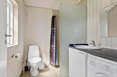 a bathroom with a toilet and a sink at LK528-Lokken-Rosavej-5 in Løkken