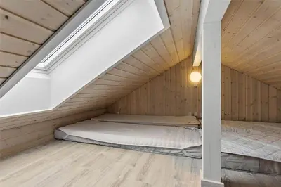 a room with a bed in a attic at LK1463-Lokken-Rosavej-11 in Løkken