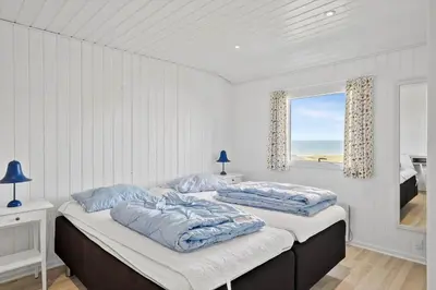 two beds in a white room with a window at LK1609-Lokken-Kettrup-Bjerge-Vej-82 in Løkken