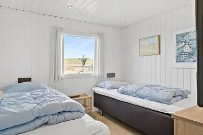 two beds in a room with a window at LK1609-Lokken-Kettrup-Bjerge-Vej-82 in Løkken