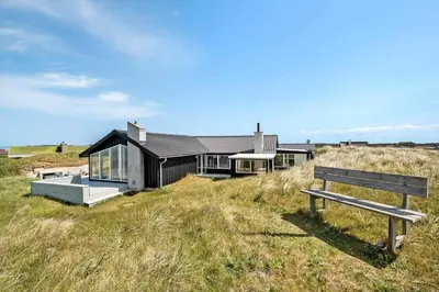 a house on a hill with a bench in front of it at LK1609-Lokken-Kettrup-Bjerge-Vej-82 in Løkken