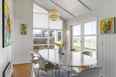 a dining room with a white table and chairs at LK329-Lokken-Marensvej-12 in Løkken