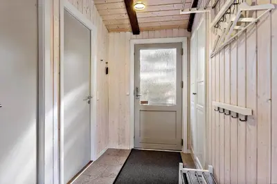 a hallway with a white door and a window at LK741-Lokken-Madsinesvej-1 in Løkken