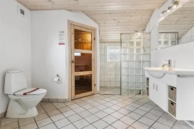 a bathroom with a toilet and a sink and a shower at LK862-Lokken-Olgavej-49 in Løkken