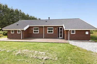 a wooden house with a large yard at LK862-Lokken-Olgavej-49 in Løkken