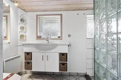 a bathroom with a sink and a toilet at LK862-Lokken-Olgavej-49 in Løkken