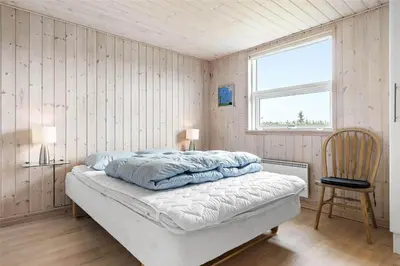 a bedroom with a bed with two pillows on it at LK862-Lokken-Olgavej-49 in Løkken