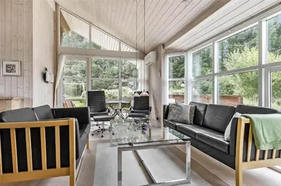 a living room with a couch and a glass table at LK862-Lokken-Olgavej-49 in Løkken