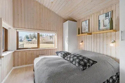 a bedroom with a bed and a window at LK537-Lokken-Mievej-20 in Løkken